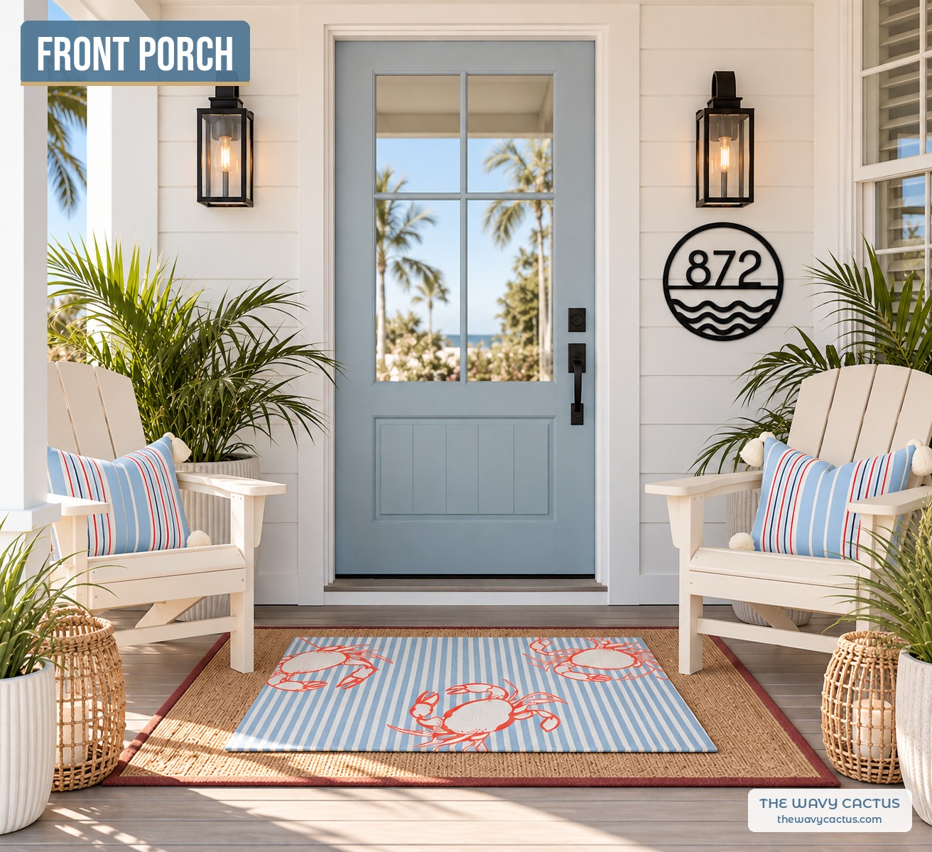 Coastal front porch with a custom house number sign, a blue stripe crab doormat over a red-bordered jute rug, a white Adirondack chair with a stripe tassel pillow, rattan lanterns, faux potted grass, and a black wall sconce