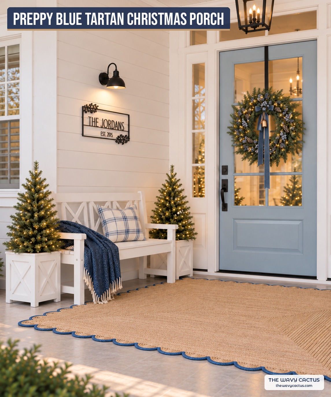 Preppy blue tartan Christmas porch with white lattice bench, plaid pillow, personalized family name sign, pre-lit trees in white planters, blue bow wreath and scalloped jute rug